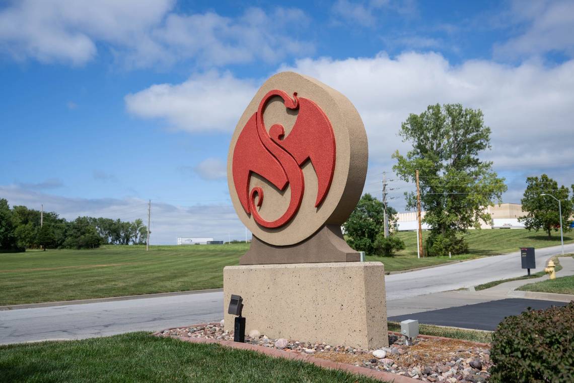 Strange Music serpent and bat logo sign at the entrance to the headquarters