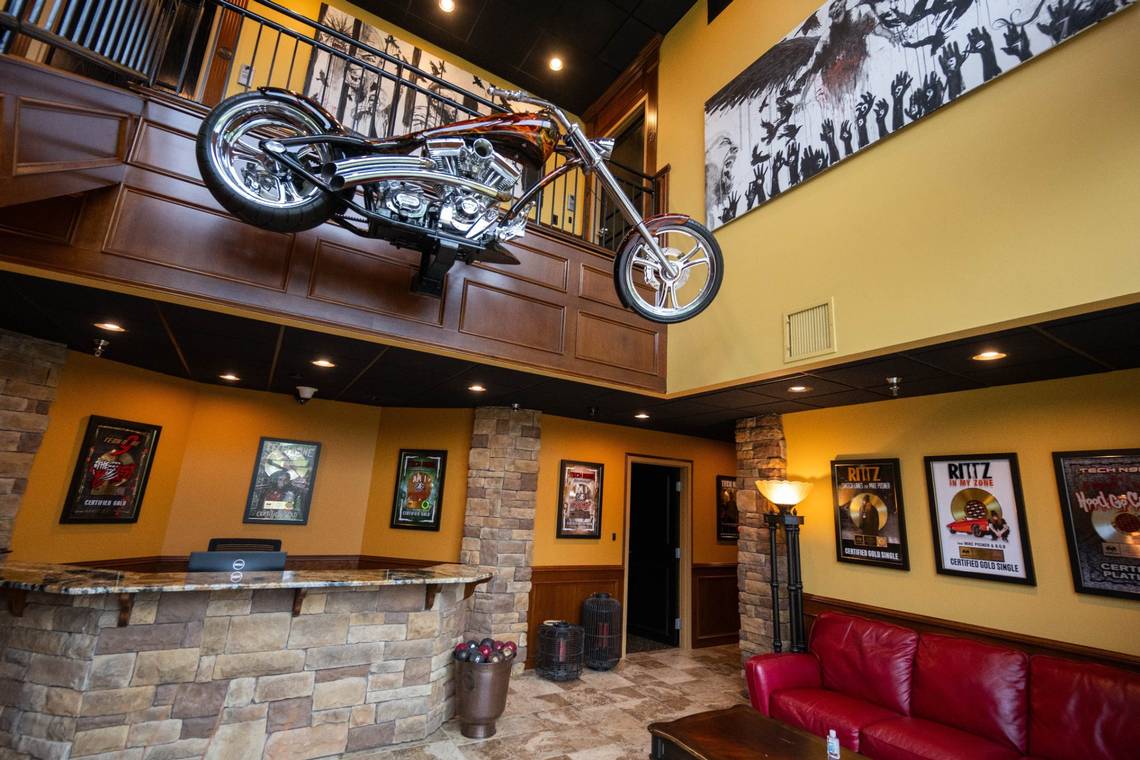 Interior of the Strange Music studio building with a motorcycle above the wall